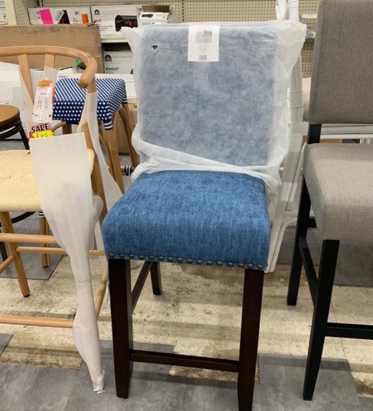 Blue upholstered bar stool with nailhead trim
