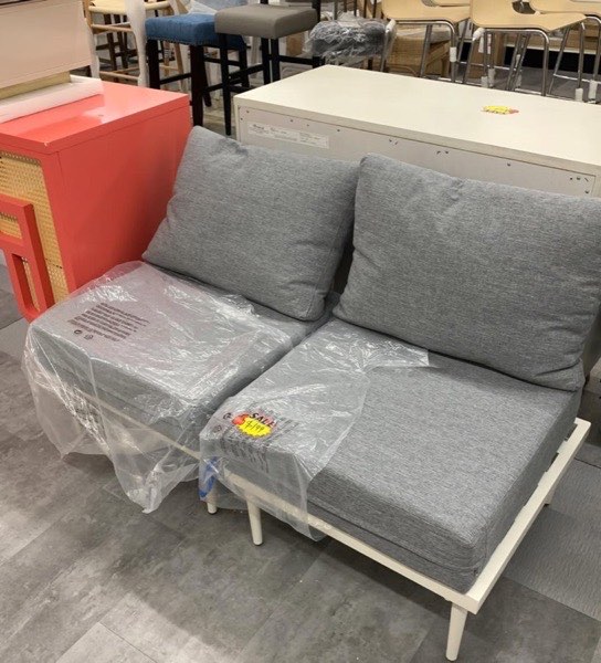 Grey upholstered loveseat on the Middletown Home Outlet floor