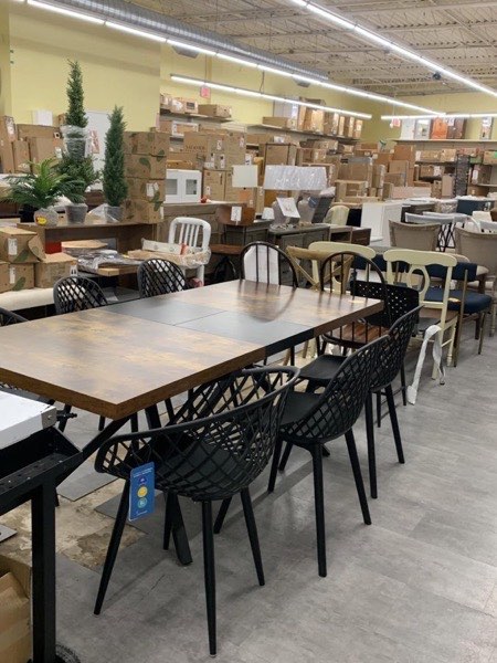 Dining tables and chairs on the warehouse showroom floor