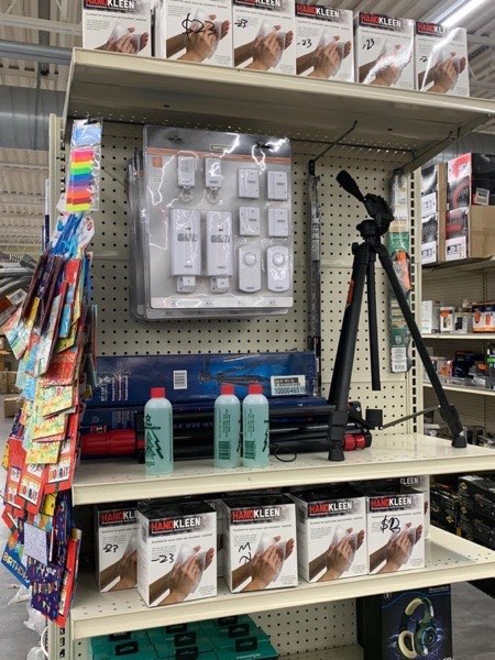 Power tools and tripod stand on hardware shelves